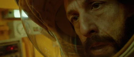 Close-up of a man's pensive face in a spaceman helmet from the movie Spaceman (2024) - HD desktop wallpaper and background.