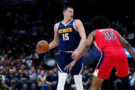 HD Denver Nuggets desktop wallpaper featuring the team's player in the iconic number 15 jersey poised with a basketball during an NBA game.
