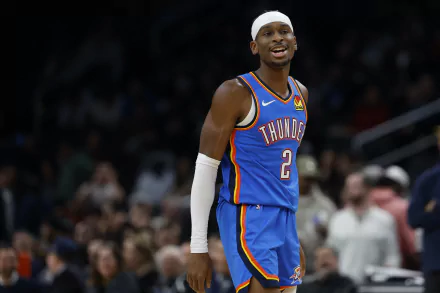 Shai Gilgeous-Alexander smiles in his Oklahoma City Thunder uniform during an NBA game, captured in this vibrant HD desktop wallpaper.