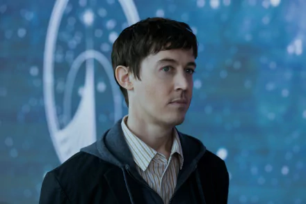 Alex Sharp in a scene from the TV show Three Body Problem, featuring a blurred cosmic background. This HD wallpaper showcases a moment of contemplation and intrigue.