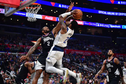 An HD desktop wallpaper featuring a Dallas Mavericks player executing a layup, with a defender from the opposing team close behind during an NBA basketball game.
