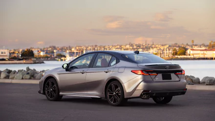 HD desktop wallpaper featuring a Toyota Camry XSE parked by the waterfront during twilight, highlighting the car's sleek design and modern aesthetics.