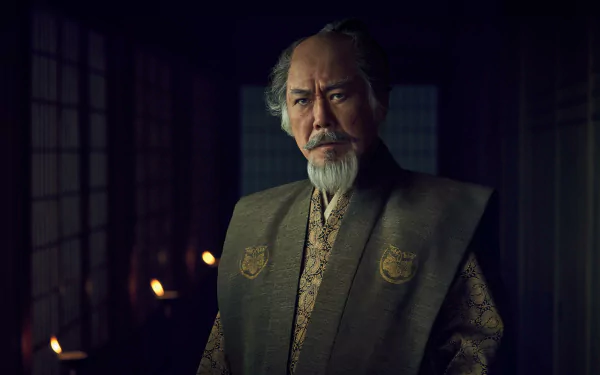 HD wallpaper featuring a still of a character from the 2024 TV show Shogun, set in a dimly lit room with traditional decor.