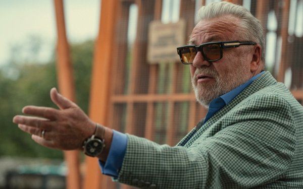 Scene from The Gentlemen (2024) TV show depicting a well-dressed character with sunglasses gesturing, ideal for HD desktop wallpaper and background.