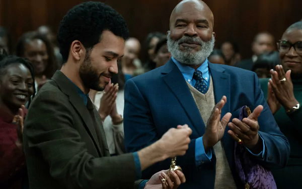 HD wallpaper featuring a scene from the TV show The American Society of Magical Negroes with two male actors engaging in applause in a courtroom setting, evoking a sense of accomplishment and unity among the audience.
