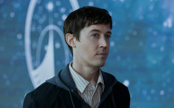 Alex Sharp in a scene from the TV show Three Body Problem, featuring a blurred cosmic background. This HD wallpaper showcases a moment of contemplation and intrigue.