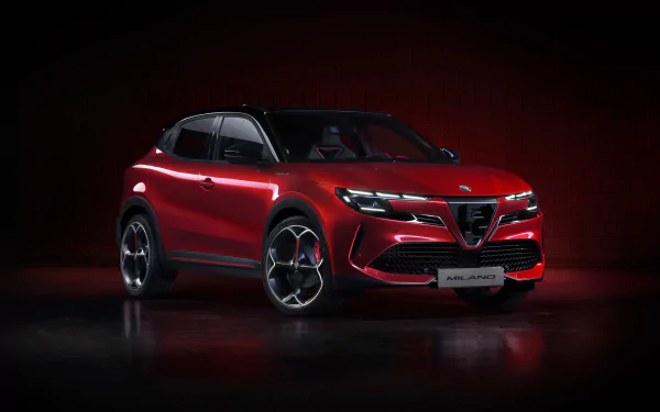 A red Alfa Romeo Milano Veloce on a dark background, showcased as an HD desktop wallpaper.