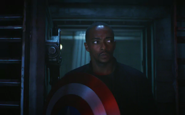 HD wallpaper featuring a character from the movie Captain America: Brave New World holding the iconic shield, standing in a dimly lit environment with a serious expression.