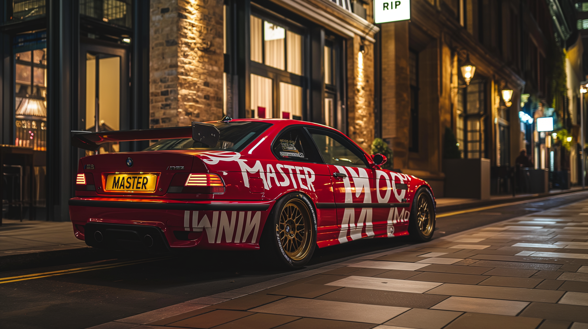 HD PC desktop wallpaper of a red BMW M3 with bold white MASTER branding, parked on a city street at night under warm streetlights.