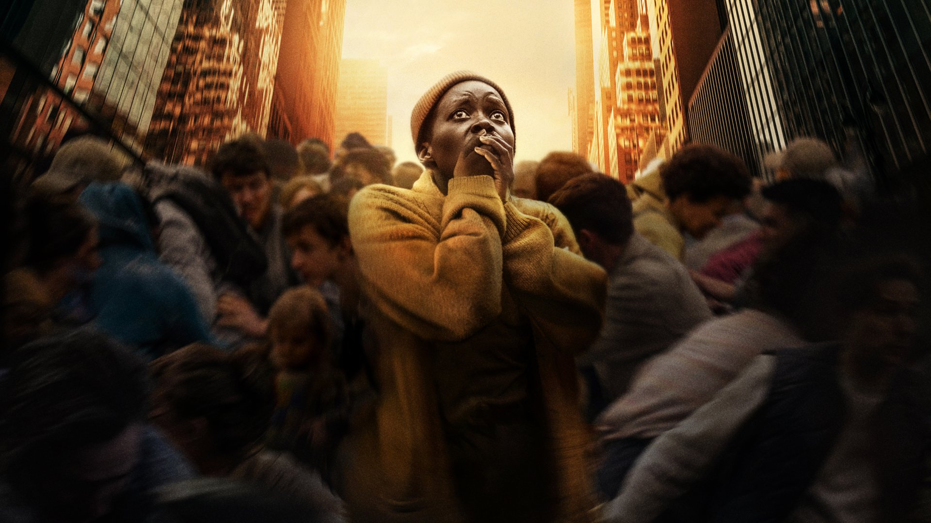 HD desktop wallpaper from the movie A Quiet Place: Day One, featuring Lupita Nyong'o surrounded by a crowd in a city setting, capturing a tense moment.