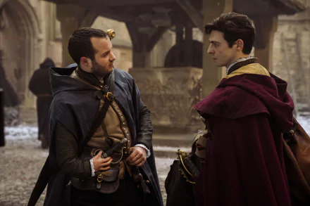 HD desktop wallpaper from the TV show Shardlake featuring two characters dressed in historical costumes, conversing in a medieval street setting.
