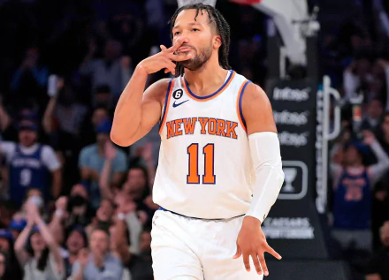 HD desktop wallpaper of Jalen Brunson in a New York Knicks jersey, celebrating during an NBA game.