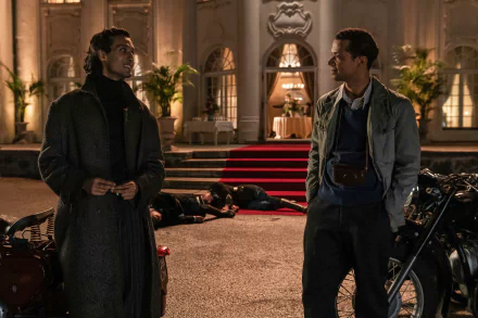 HD wallpaper from Interview with the Vampire featuring two characters conversing in front of an elegant building with motorcycles and bodies on the ground.