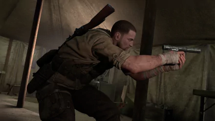 An HD wallpaper of Sniper Elite III, featuring a character in combat gear, stealthily aiming his weapon inside a dimly lit tent.