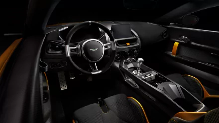 HD desktop wallpaper featuring a sleek and modern interior of an Aston Martin Valiant, showcasing polished black surfaces, ergonomic design and high-end finishes.