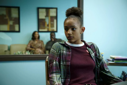 Image from the movie Sound of Hope: The Story of Possum Trot showing a young woman in a maroon sweater and plaid shirt, seated indoors with two people in the background. HD desktop wallpaper and background.