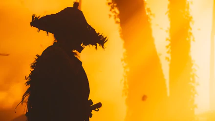 HD desktop wallpaper featuring a dramatic silhouette of a samurai from the video game Ghost of Tsushima, set against an intense, fiery background.