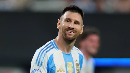 Lionel Messi in Argentina's national football team jersey, smiling on the field. HD desktop wallpaper and background.