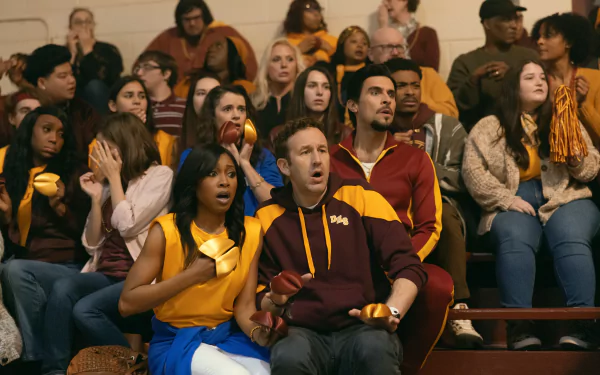 HD desktop wallpaper from The Big Door Prize featuring an attentive audience with surprised expressions at an event.