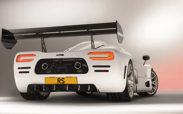 HD desktop wallpaper featuring the rear view of a white Ultima RS sports car with distinctive aerodynamic wing and RS license plate.