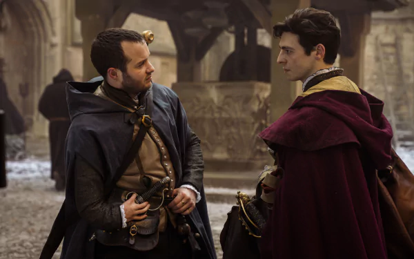 HD desktop wallpaper from the TV show Shardlake featuring two characters dressed in historical costumes, conversing in a medieval street setting.