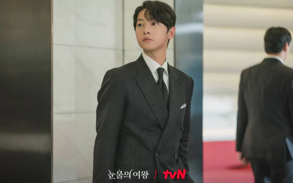 HD desktop wallpaper from the TV show Queen of Tears, featuring a man in a pinstripe suit looking thoughtful in a modern office setting.