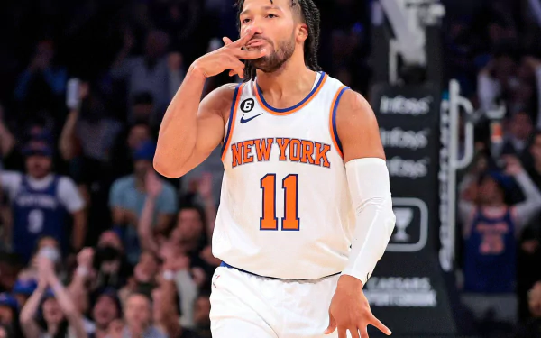 HD desktop wallpaper of Jalen Brunson in a New York Knicks jersey, celebrating during an NBA game.