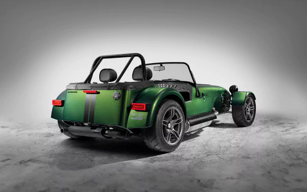 HD desktop wallpaper of a Caterham Seven 485 car in vibrant green, featuring a sleek and sporty rear view against a neutral backdrop.