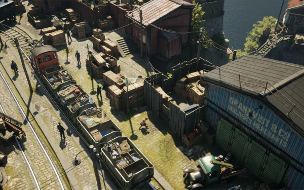 HD desktop wallpaper and background of Eriksholm: The Stolen Dream video game, showcasing a train yard with industrial buildings, tracks, and numerous characters and crates scattered around.
