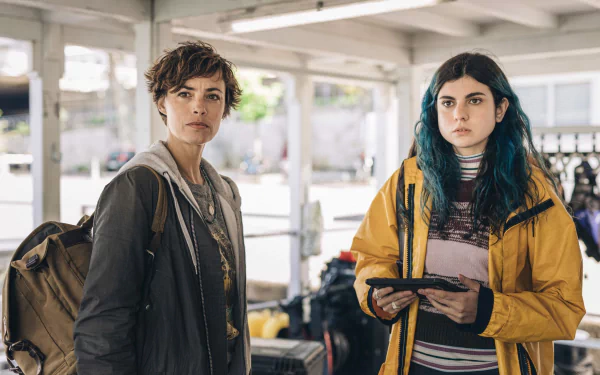 Two individuals on a movie set for Under Paris. The image is a HD desktop wallpaper and background.