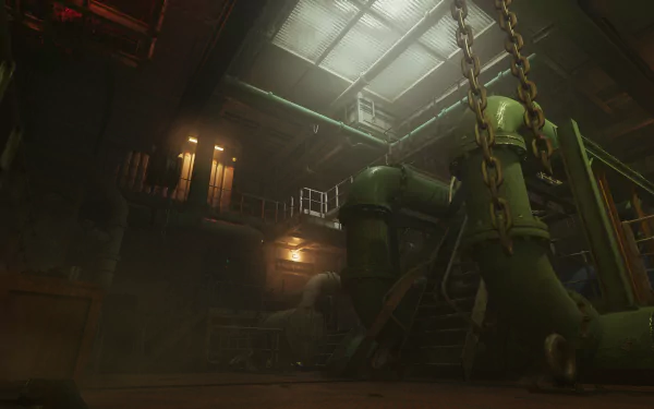 An HD desktop wallpaper of the video game Still Wakes the Deep, featuring a dimly lit industrial setting with large green pipes and heavy chains.