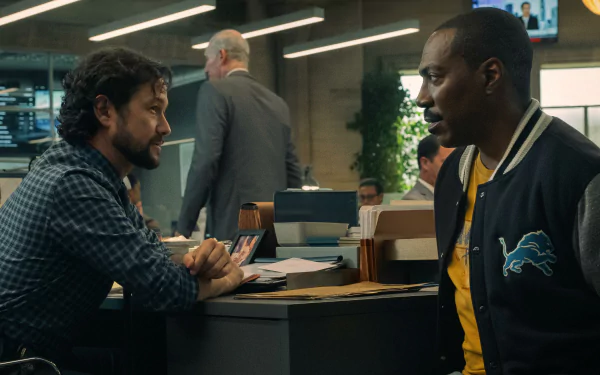 HD desktop wallpaper featuring a scene from Beverly Hills Cop: Axel F, with two men engaged in a conversation in an office setting.