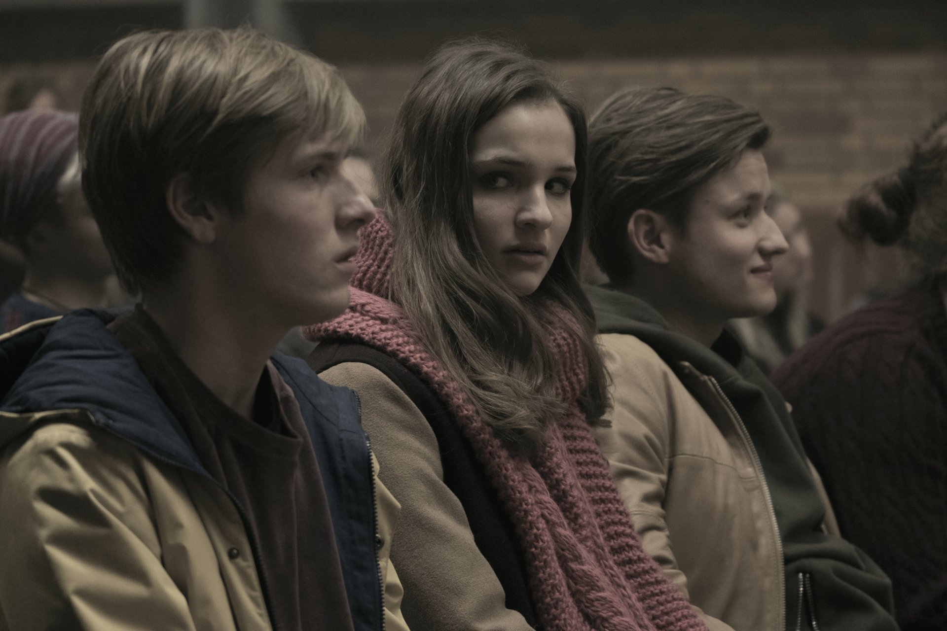 HD wallpaper featuring characters from the TV show Dark, highlighting Louis Hofmann and Lisa Vicari in an atmospheric setting.
