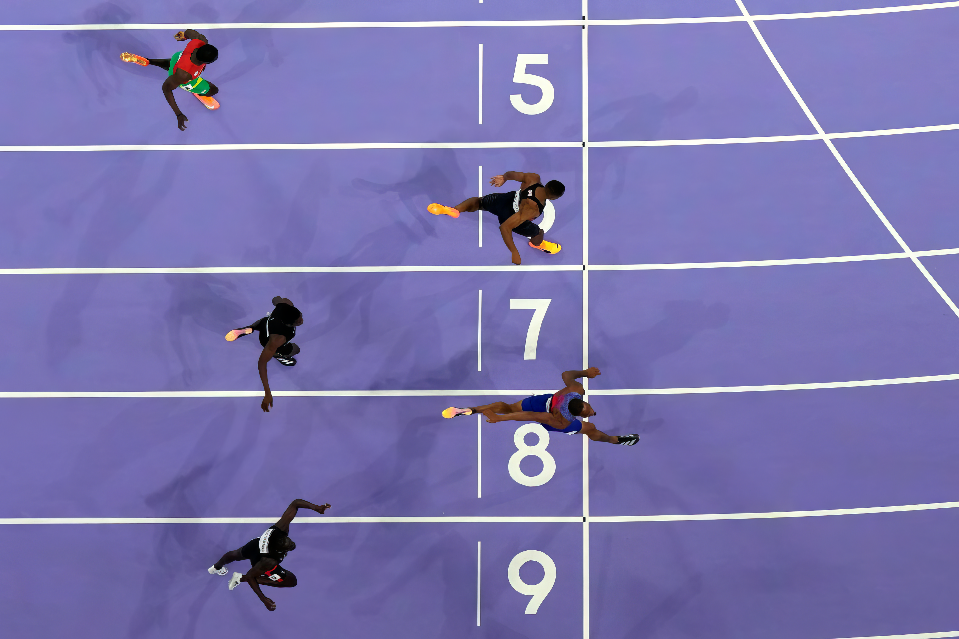 An HD desktop wallpaper featuring the excitement of sprinting at the Olympic Games Paris 2024, showcasing the spirit of sports and the United States' athletic prowess.