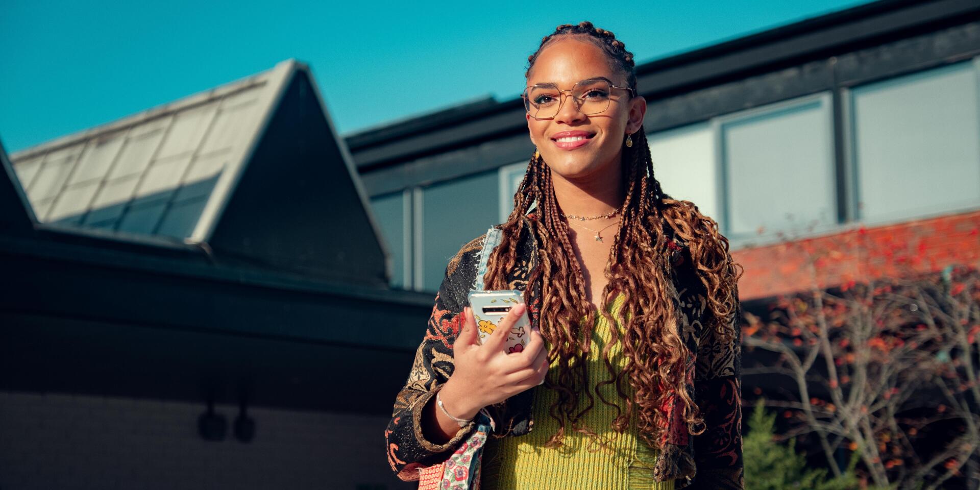 4K Ultra HD PC wallpaper featuring a smiling character from the TV show Heartstopper, holding a phone against a bright outdoor backdrop.