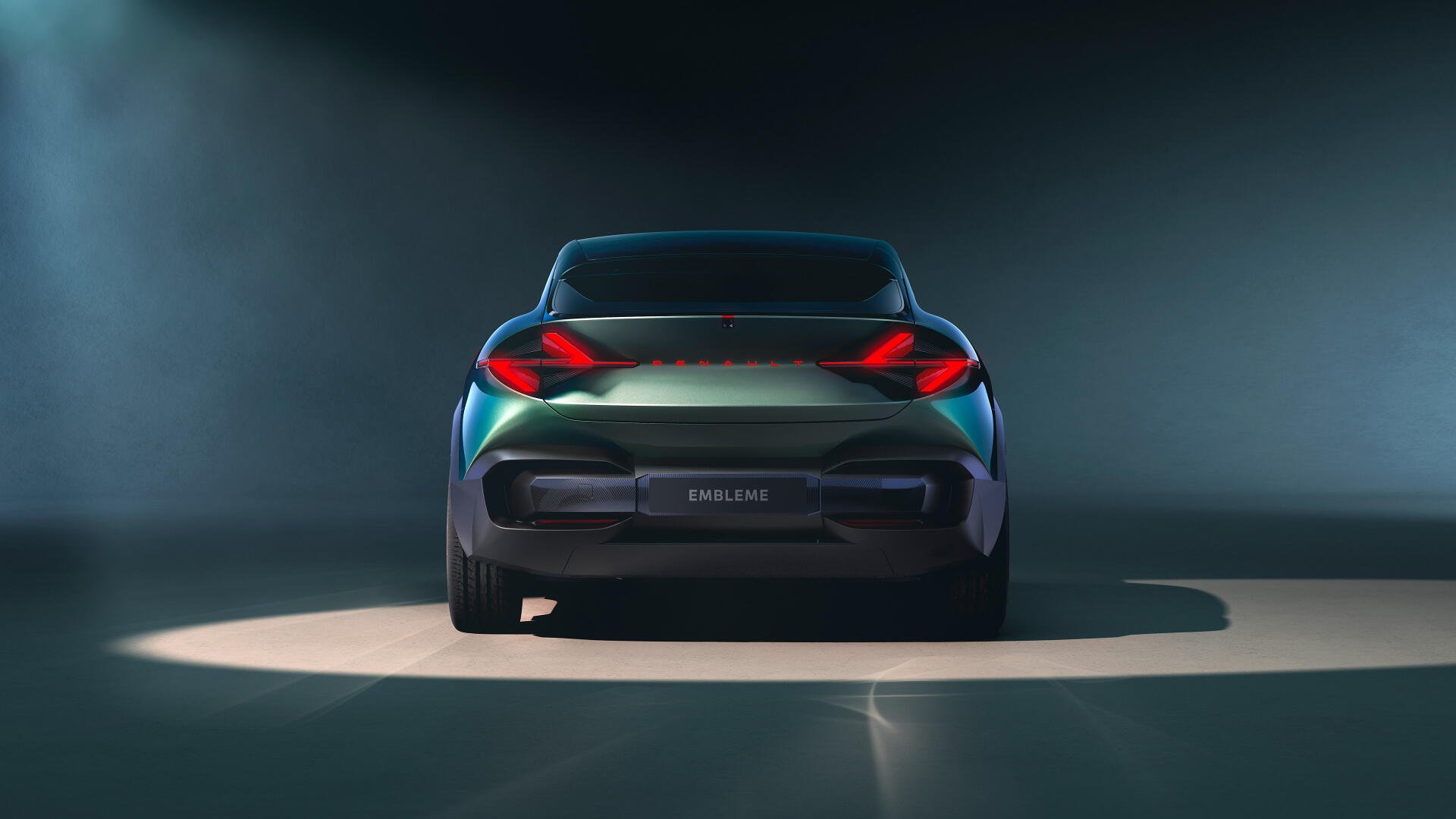 Rear view of a sleek Renault car with illuminated taillights and Renault emblem, captured in a 4K Ultra HD desktop wallpaper setting.