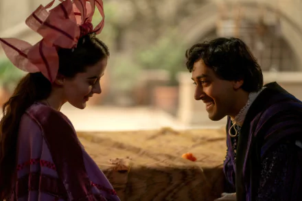A scene from the TV show The Decameron, featuring two characters in vibrant costumes sharing a moment, set against a soft, blurred background. This makes a captivating HD desktop wallpaper.