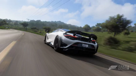 HD PC desktop wallpaper featuring a McLaren 765LT vehicle from the video game Forza Horizon 5, captured speeding on a scenic road.