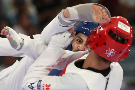A dynamic taekwondo match showcasing intense competition at the Olympic Games Paris 2024, featuring athletes in protective gear, capturing the spirit of sportsmanship and skill.