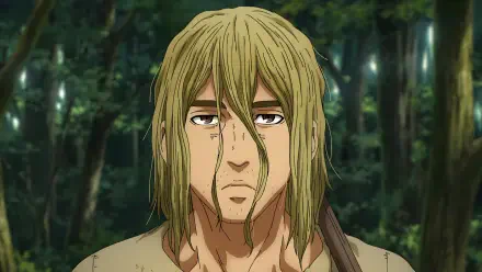 HD desktop wallpaper featuring Thorfinn from Vinland Saga, showcasing the anime character in a forested background, capturing a moment of introspection and determination.