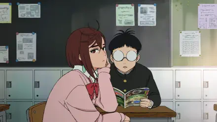 HD anime wallpaper featuring Momo Ayase and Ken Takakura from Dandadan in a classroom setting, with Momo resting her chin on her hand and Ken reading a comic.