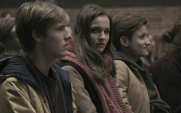 HD wallpaper featuring characters from the TV show Dark, highlighting Louis Hofmann and Lisa Vicari in an atmospheric setting.