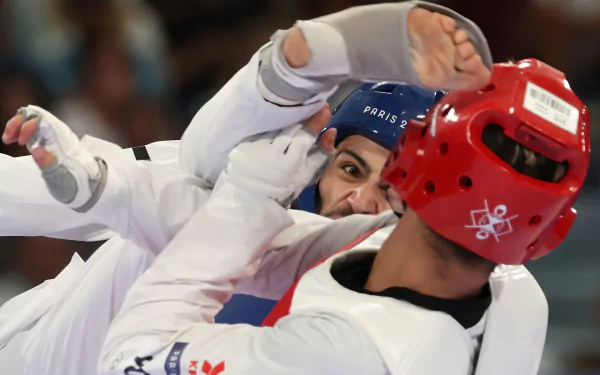 A dynamic taekwondo match showcasing intense competition at the Olympic Games Paris 2024, featuring athletes in protective gear, capturing the spirit of sportsmanship and skill.
