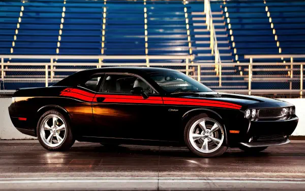 A stunning HD wallpaper featuring a classic Dodge Challenger R/T, showcasing its timeless design and powerful presence on the road. A must-have for car enthusiasts.