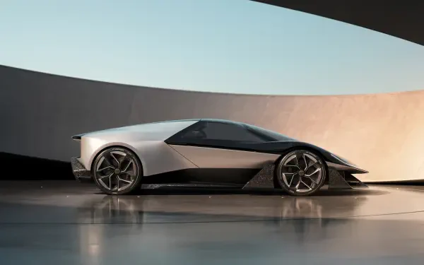 A sleek Lotus Theory 1 car is showcased against a modern architectural backdrop, presented as a stunning 4K Ultra HD desktop wallpaper.