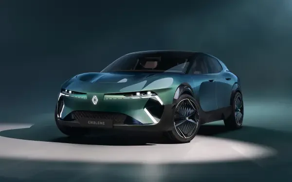 A sleek Renault vehicle showcased in a striking green color, featuring the Renault emblem, set against a dramatic backdrop. This 4K Ultra HD image serves as a stunning desktop wallpaper.