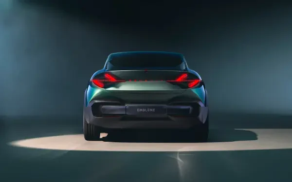 Rear view of a sleek Renault car with illuminated taillights and Renault emblem, captured in a 4K Ultra HD desktop wallpaper setting.