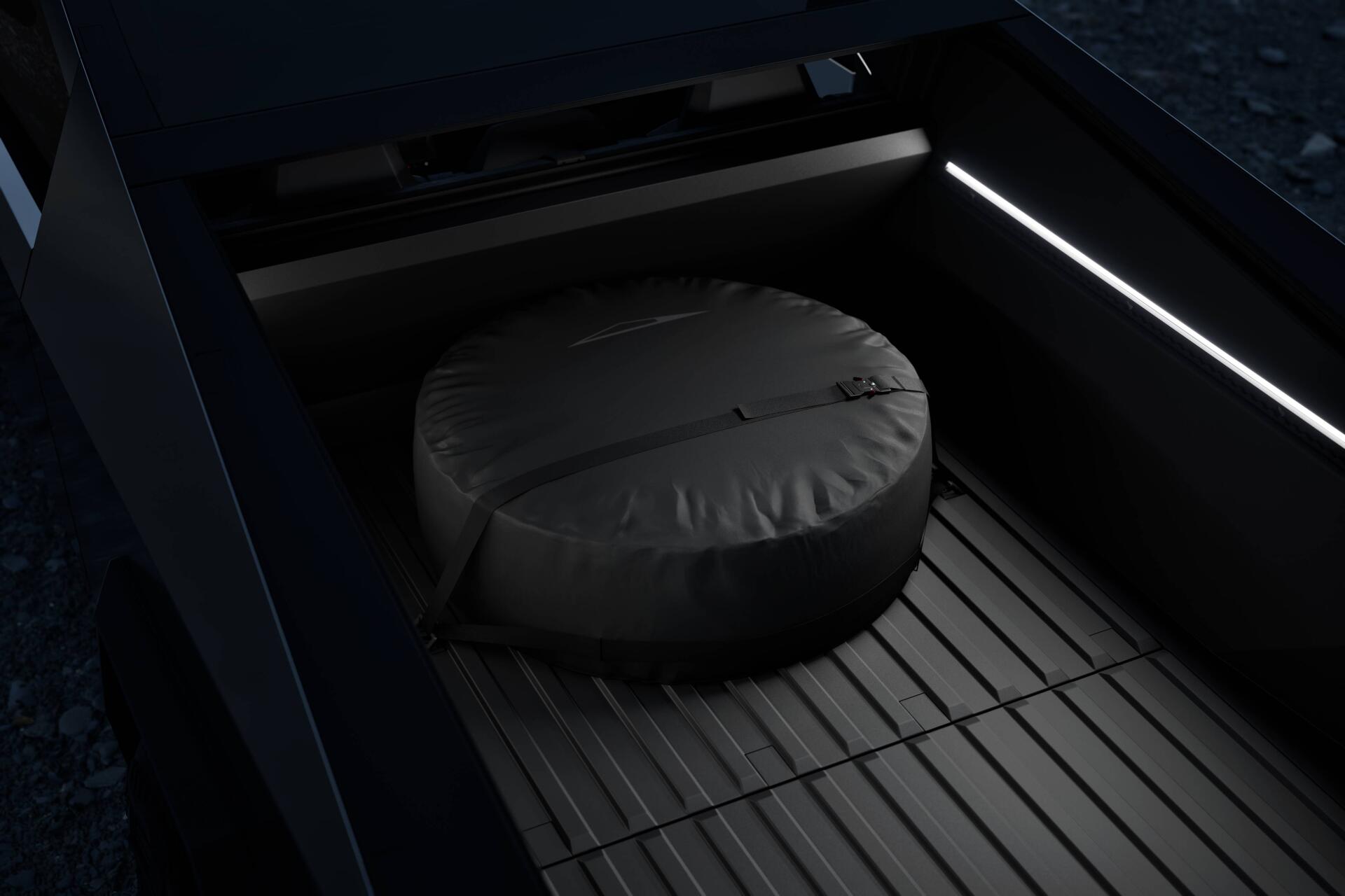 Close-up view of a Tesla Cybertruck's bed, featuring a round storage cover and sleek interior lighting, showcased as a 4K Ultra HD desktop wallpaper.