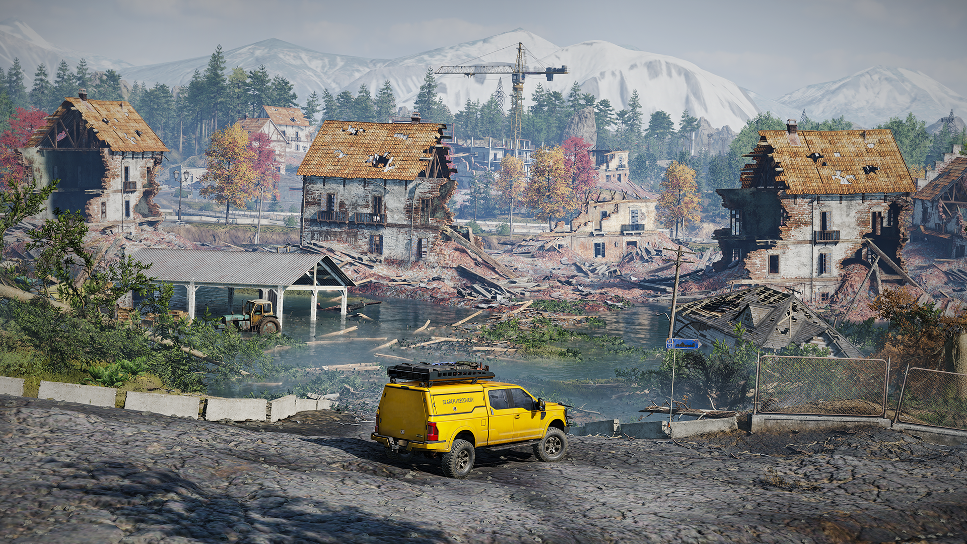 A scenic HD wallpaper from the video game RoadCraft, featuring a yellow vehicle near a lake surrounded by damaged houses and mountains in the background.