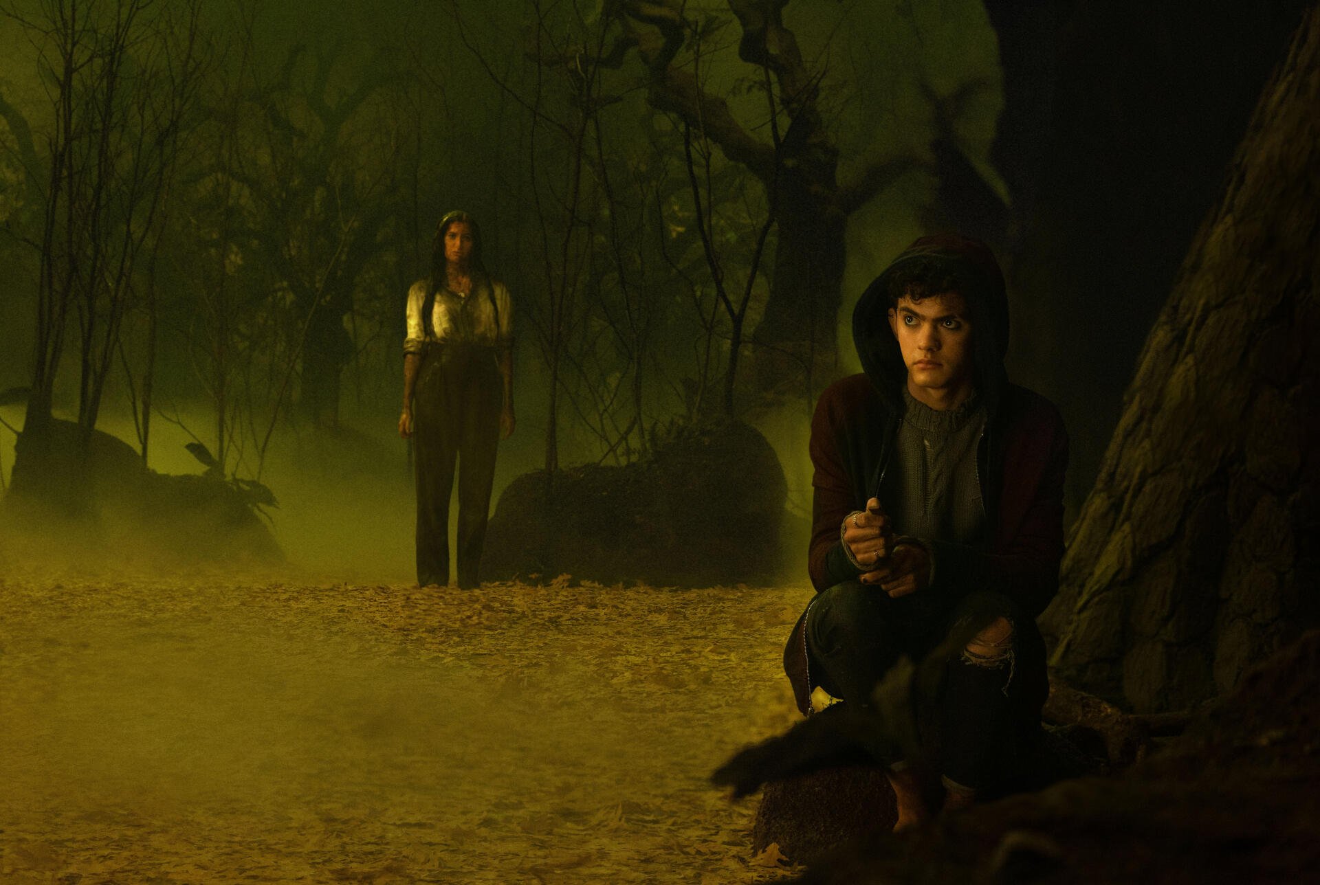 A captivating 4K Ultra HD wallpaper from the TV show Agatha All Along, featuring two characters in a mysterious, dark forest setting, enhancing the intrigue and atmosphere.